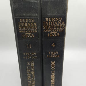 May include: Two black leather-bound volumes of the 1933 Annotated Indiana Statutes, volumes 11 and 4. Volume 11 covers real property to weights and measures, sections 56-101 to 69-407. Volume 4 covers the criminal code, sections 9-101 to 13-1309. Both volumes are published by Bobbs-Merrill.