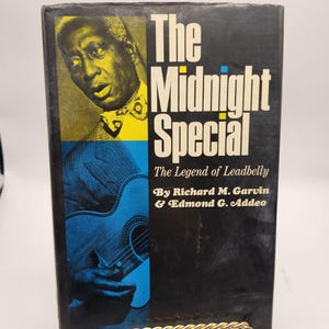 May include: A black and yellow book titled "The Midnight Special: The Legend of Leadbelly" by Richard M. Garvin & Edmond G. Addeo. The cover features a black and white photo of a man with a guitar.