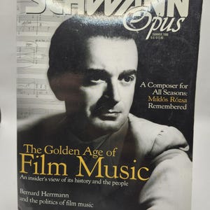 Op de afbeelding: Een vintage uitgave van het Schwann Opus magazine, zomer 1996, met een portret van een man en de titel "The Golden Age of Film Music". De cover bevat tekst over Miklós Rózsa en Bernard Herrmann.