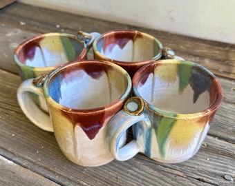 Rainbow ceramic mug was handmade on the wheel glazed in rainbow drips and white holds 17oz