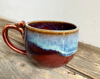 Tea cup handmade on wheel in red and blue holds 15oz