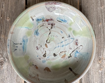 Curved plate bowl handmade on wheel in beige and splatter glaze 7.25”