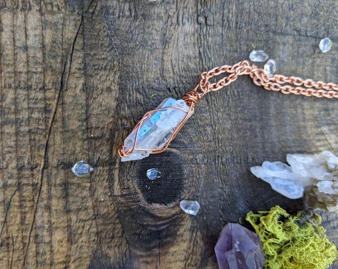 Angel aura and faden quartz combo pendant, high quality mini faden quartz crystal cluster next to an opal aura crystal point, natural high q