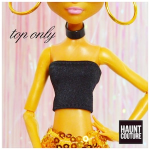 May include: Black strapless top for a doll, with the text "top only" in the image.