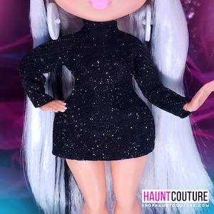 May include: A black sparkly mini dress with a mock neck and long sleeves. The dress is made of a soft, stretchy fabric and has a fitted silhouette.