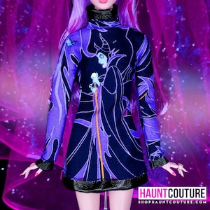 May include: A black and purple dress with a graphic print of Maleficent from the Disney movie Sleeping Beauty. The dress has a turtleneck and long sleeves.
