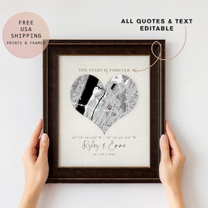 May include: Framed print featuring a heart-shaped map in black and white, with a red dot marking a location. The text "THE START of FOREVER" is above the map. Below the map are names and a date. The frame is dark brown.