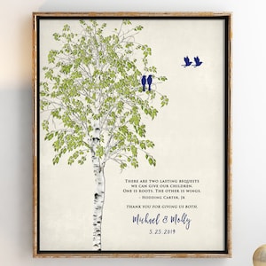May include: A framed print with a watercolor illustration of a birch tree with green leaves and a white trunk. Three blue birds are perched on a branch and two more are flying away. The print includes a quote about giving children roots and wings, attributed to Hodding Carter Jr. The print is signed "Michael & Molly" and dated "5.25.2019".