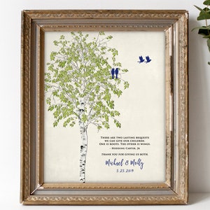 May include: A framed print with a watercolor illustration of a birch tree with green leaves and white bark. Two blue birds are perched on a branch and two more are flying above. The print includes a quote about giving children roots and wings, and is signed "Michael & Molly" with the date "5.25.2019".