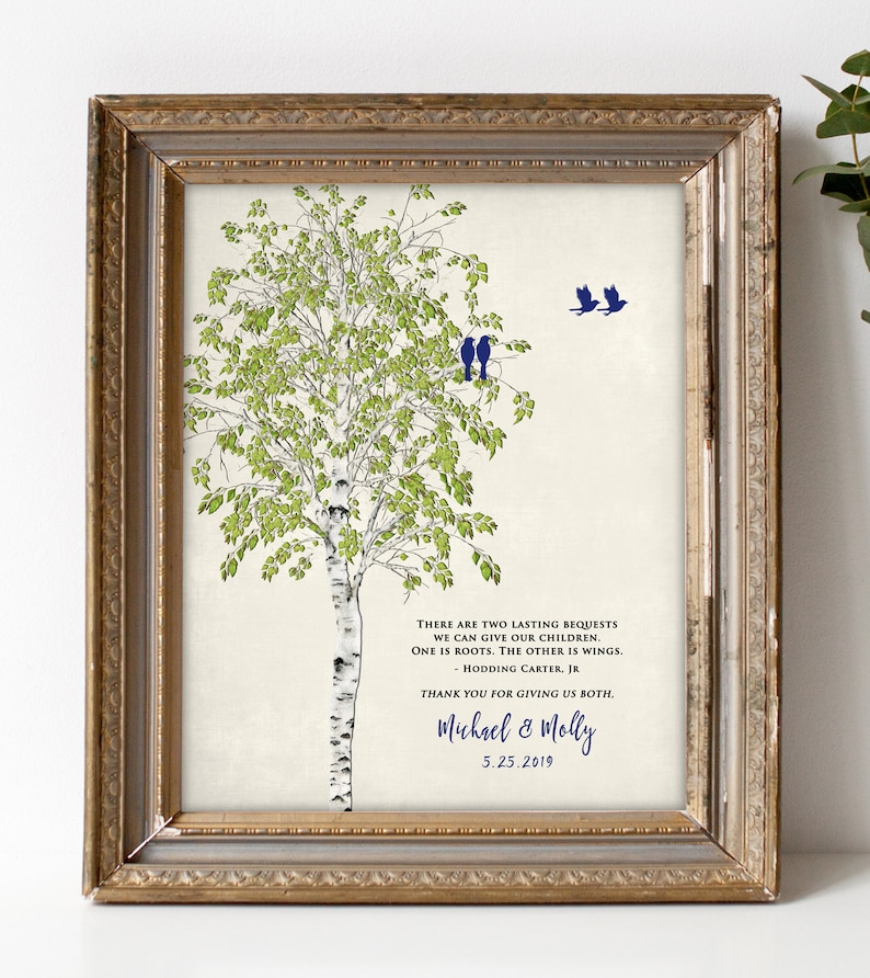 May include: A framed print with a watercolor illustration of a birch tree with green leaves and white bark. Two blue birds are perched on a branch and two more are flying above. The print includes a quote about giving children roots and wings, and is signed "Michael & Molly" with the date "5.25.2019".