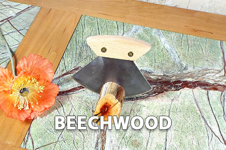 May include: A close-up of a small, hand-crafted wood carving tool with a wooden handle and a metal blade. The tool is resting on a green and brown marble surface. The text "BEECHWOOD" is visible in the image.