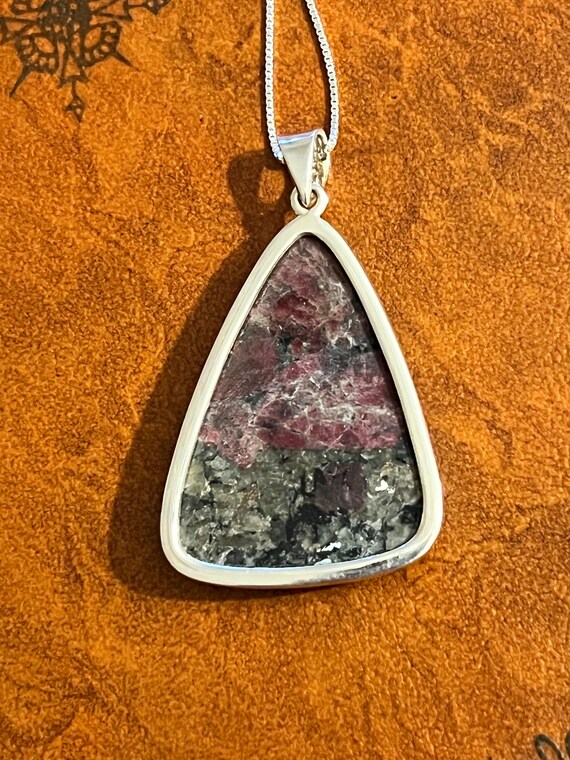 A purple triangular shaped Eudyalite crystal pend… - image 4