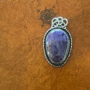 A unique purple charoite crystal pendant with .925 sterling silver