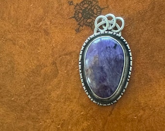A unique purple charoite crystal pendant with .925 sterling silver