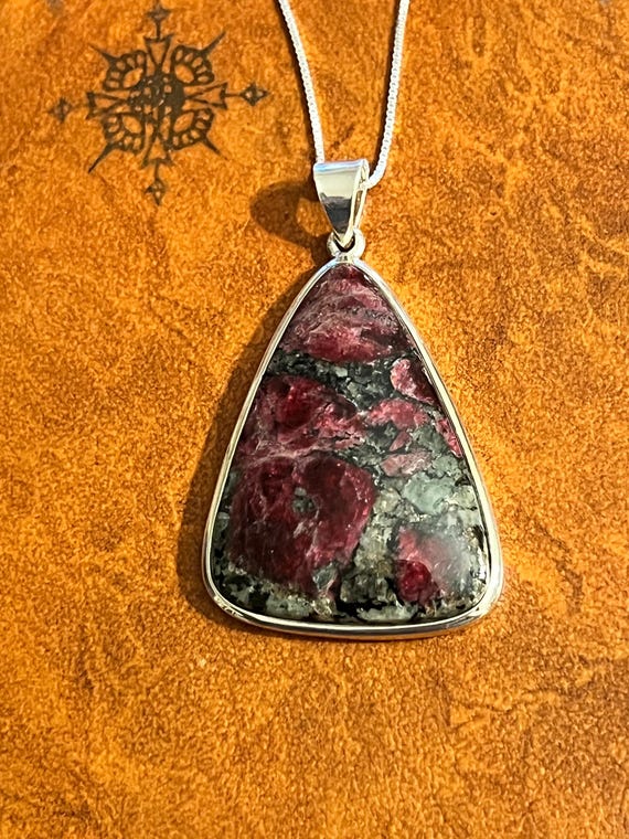 A purple triangular shaped Eudyalite crystal pend… - image 1
