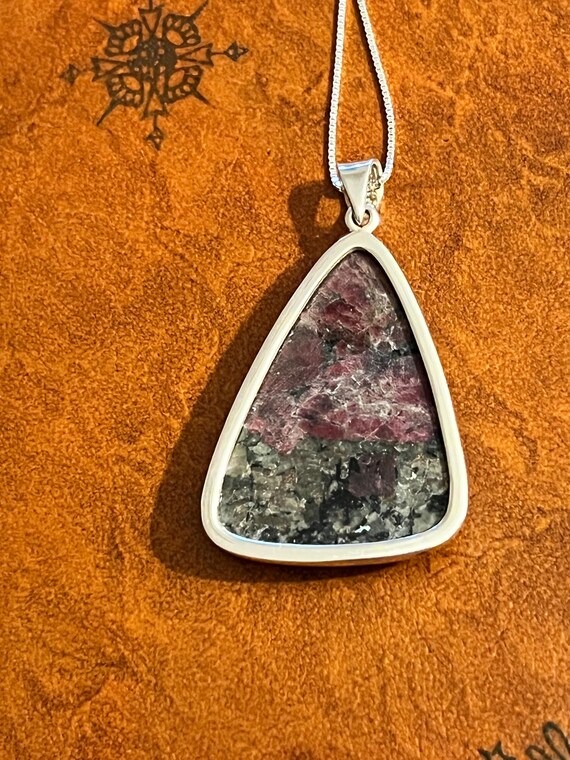 A purple triangular shaped Eudyalite crystal pend… - image 3