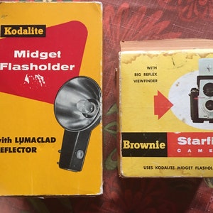 May include: Two boxes for a Kodak camera flash and a Brownie Starflex camera. The flash box is yellow with red accents and says "Kodalite Midget Flasholder with LUMACLAD REFLECTOR". The camera box is yellow with red accents and says "Brownie Starflex CAMERA USES KODALITE MIDGET FLASHOLDER".