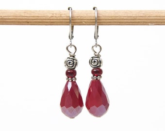 Stainless steel drip earrings with red glass cut bead and a rose