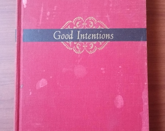 May include: A hardcover book titled "Good Intentions" by Ogden Nash. The book has a vibrant pink cover with a dark blue band across the middle. The title is in gold lettering, and the author's name is in white.