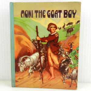 May include: A vintage children's book cover with a colorful illustration of a boy with a staff and a herd of goats. The title of the book is "Mani the Goat Boy".