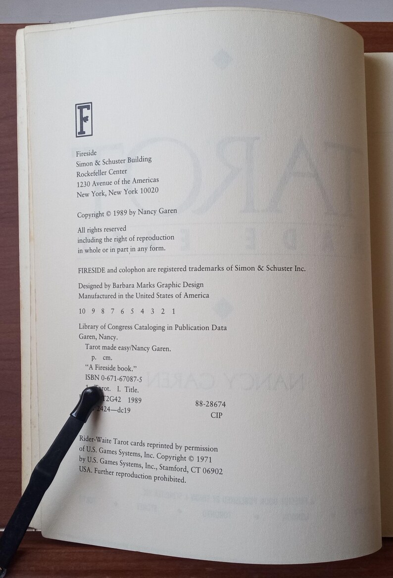 May include: A white book with the title "Tarot Made Easy" by Nancy Garen. The book cover features a large "F" in a black font. The book is published by Fireside, an imprint of Simon & Schuster.