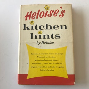 May include: A vintage book titled "Heloise's Kitchen Hints" by Heloise. The cover features a yellow background with red accents and a stylized floral design. The book offers tips on saving time, money, and energy in the kitchen.