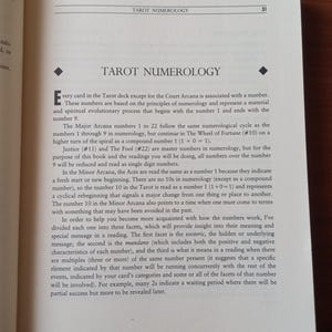 May include: A page from a book about Tarot numerology, explaining how each card is associated with a number and how the numbers relate to the spiritual and material aspects of life.
