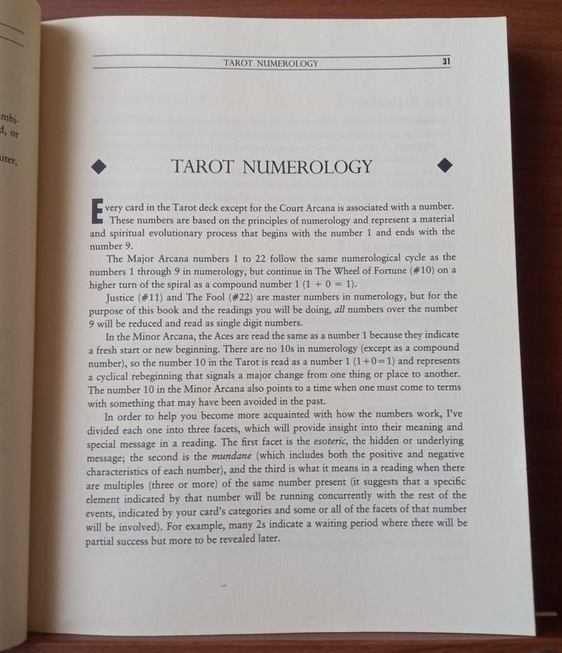 May include: A page from a book about Tarot numerology, explaining how each card is associated with a number and how the numbers relate to the spiritual and material aspects of life.