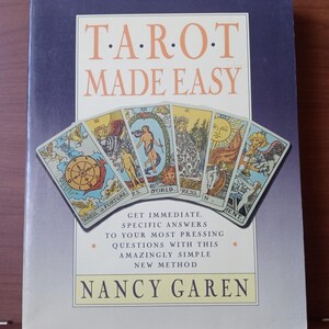 May include: A book titled "Tarot Made Easy" with a purple cover and a colourful illustration of tarot cards. The book cover includes the text "Get Immediate, Specific Answers to Your Most Pressing Questions with this Amazingly Simple New Method." and the author's name "Nancy Garen".