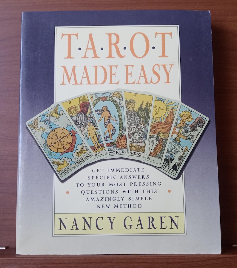 May include: A book titled "Tarot Made Easy" with a purple cover and a colourful illustration of tarot cards. The book cover includes the text "Get Immediate, Specific Answers to Your Most Pressing Questions with this Amazingly Simple New Method." and the author's name "Nancy Garen".