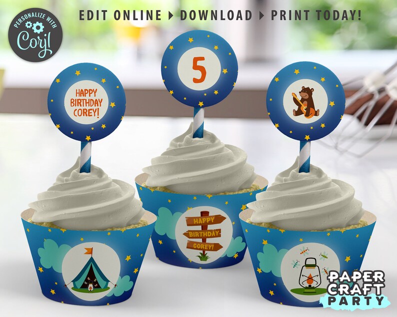 May include: Blue and white cupcake wrappers with a camping theme. The wrappers feature a tent, a lantern, and stars. The cupcake toppers are round and feature a bear playing a guitar, a number 5, and the text "Happy Birthday Corey!"