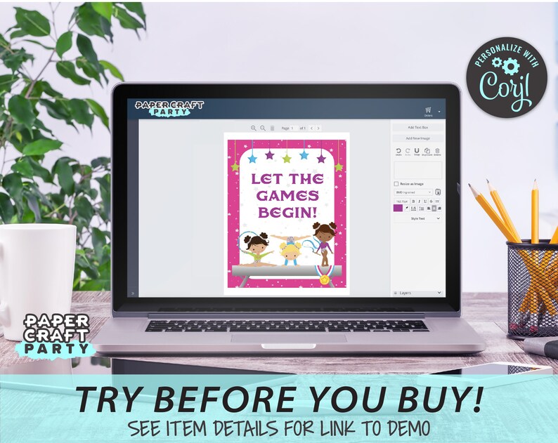 May include: A laptop screen displaying a pink and purple printable sign with the text "Let the Games Begin!" and three cartoon girls doing gymnastics. The sign is surrounded by stars. The laptop is on a wooden table with a plant and a pencil holder in the background.