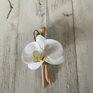 Golf theme boutonniere with a white real touch orchid