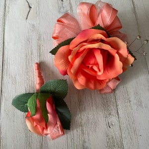 Corsage and boutonnière in coral roses