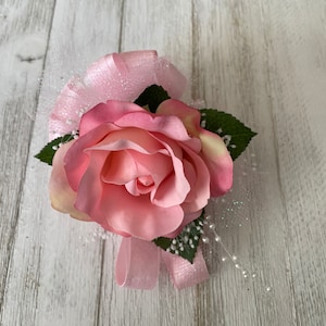 Corsage designed with a pink rose
