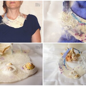 May include: A white felted necklace with blue and purple accents and seashells. The necklace is shown on a model and on a white surface.