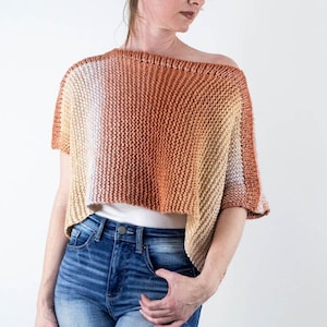 May include: A short-sleeved, off-the-shoulder knit sweater in a gradient of peach, orange, and cream colors.