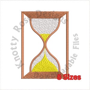 May include: A brown wooden hourglass with yellow sand. The hourglass is in a rectangular frame.