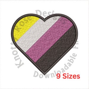 May include: Embroidered heart-shaped patch featuring the non-binary pride flag colors: yellow, white, pink, and black. The patch has a black border and the text "9 Sizes" in red. The design is suitable for various craft projects.