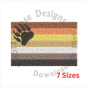 May include: Embroidered design of a brown, orange, yellow, beige, gray, and black bear pride flag with a paw print in the upper left corner. The flag has seven stripes.  Download 7 sizes.