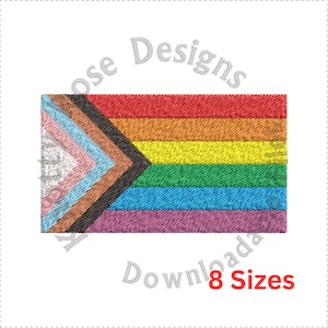 Può includere: Un disegno ricamato della bandiera del Pride con un arcobaleno e un triangolo con colori rosa, azzurro, marrone, nero e bianco. Il testo "8 Sizes" è in rosso. Il disegno è su sfondo bianco.