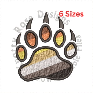 May include: A brown bear paw print with the colors of the gay pride flag. The paw print is outlined in black and has claws. The text "6 Sizes" is in the upper right corner of the image.