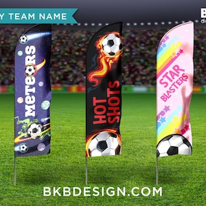 May include: Three soccer team feather flags with different designs. One is purple with "Meteors" text and soccer ball graphics. Another is black with "Hot Shots" text and a soccer ball with flames. The third is pink with "Star Blasters" text and star graphics.