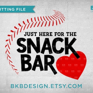 May include: A black and white graphic design with a red heart and a baseball stitch design. The text reads "Just here for the snack bar".