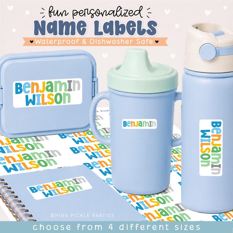 May include: A set of personalized name labels featuring the text Benjamin Wilson in blue, green, orange, and gray. The labels are applied to a light blue lunch box, a light blue sippy cup, a light blue water bottle, and a spiral notebook.