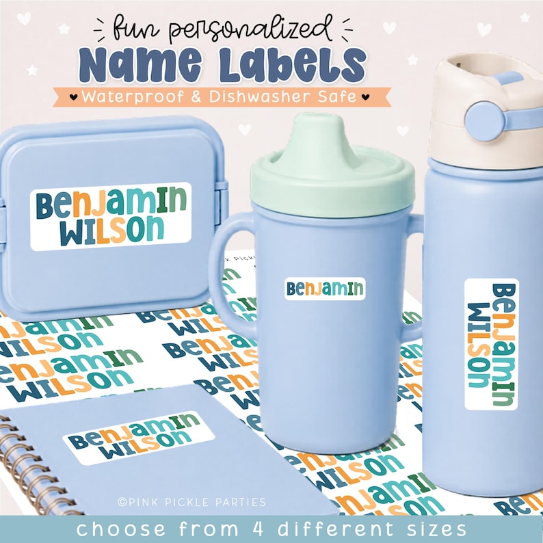 May include: A collection of light blue lunch containers, a sippy cup, and a water bottle featuring personalized white rectangular name labels with the text Benjamin Wilson in dark blue, green, and orange lettering. The labels are waterproof.