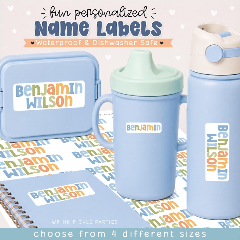 May include: A set of personalized name labels featuring the text "BENJAMIN WILSON" in blue, orange, and green. The labels are applied to a light blue snack container, a light blue sippy cup, a light blue water bottle, and a spiral-bound notebook.