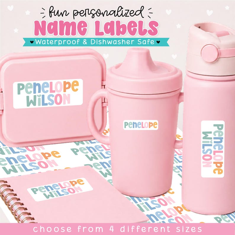 May include: A set of light pink items including a lunch box, a sippy cup, and a water bottle, each featuring white rectangular name labels with the text Penelope Wilson in colorful, rounded lettering. A spiral-bound notebook is also included.