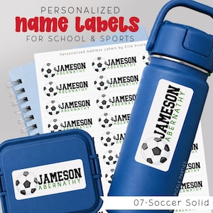 May include: Blue water bottle, lunch container, and notepad with personalized name labels. The labels feature the name "Jameson Abernathy" and a soccer ball graphic. Text at the top reads "Personalized Name Labels for School & Sports."