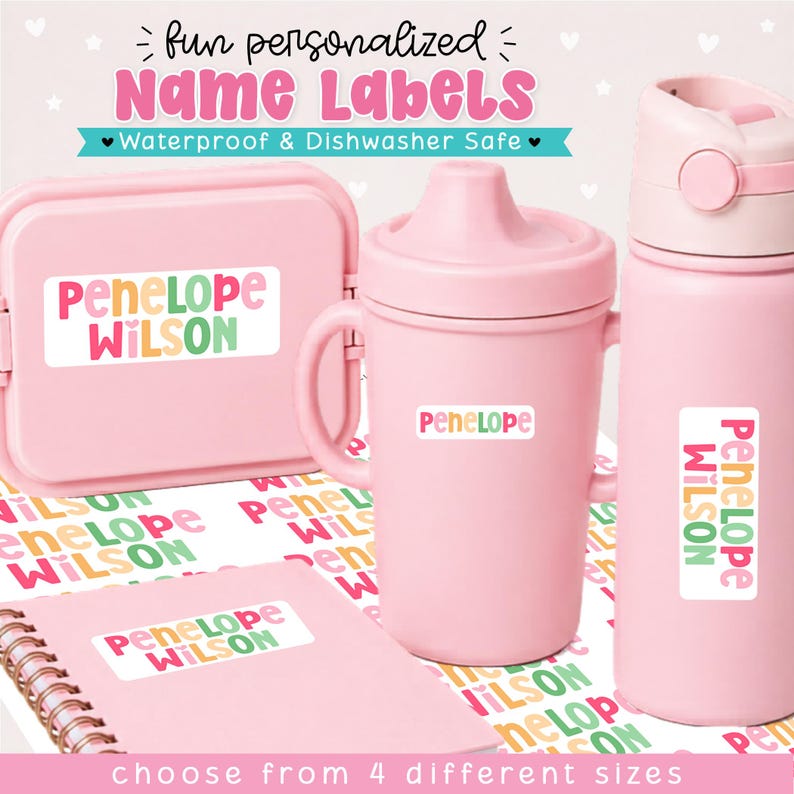 May include: A collection of light pink items including a snack container, a sippy cup, a water bottle, and a spiral notebook, all featuring personalized white rectangular name labels with the text Penelope Wilson in colorful, rounded lettering.